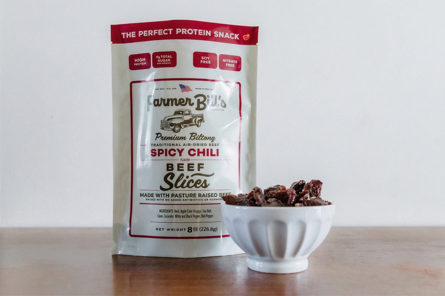 Farmer Bill's Spicy Chili Beef Slices package displayed with product poured into white bowl.